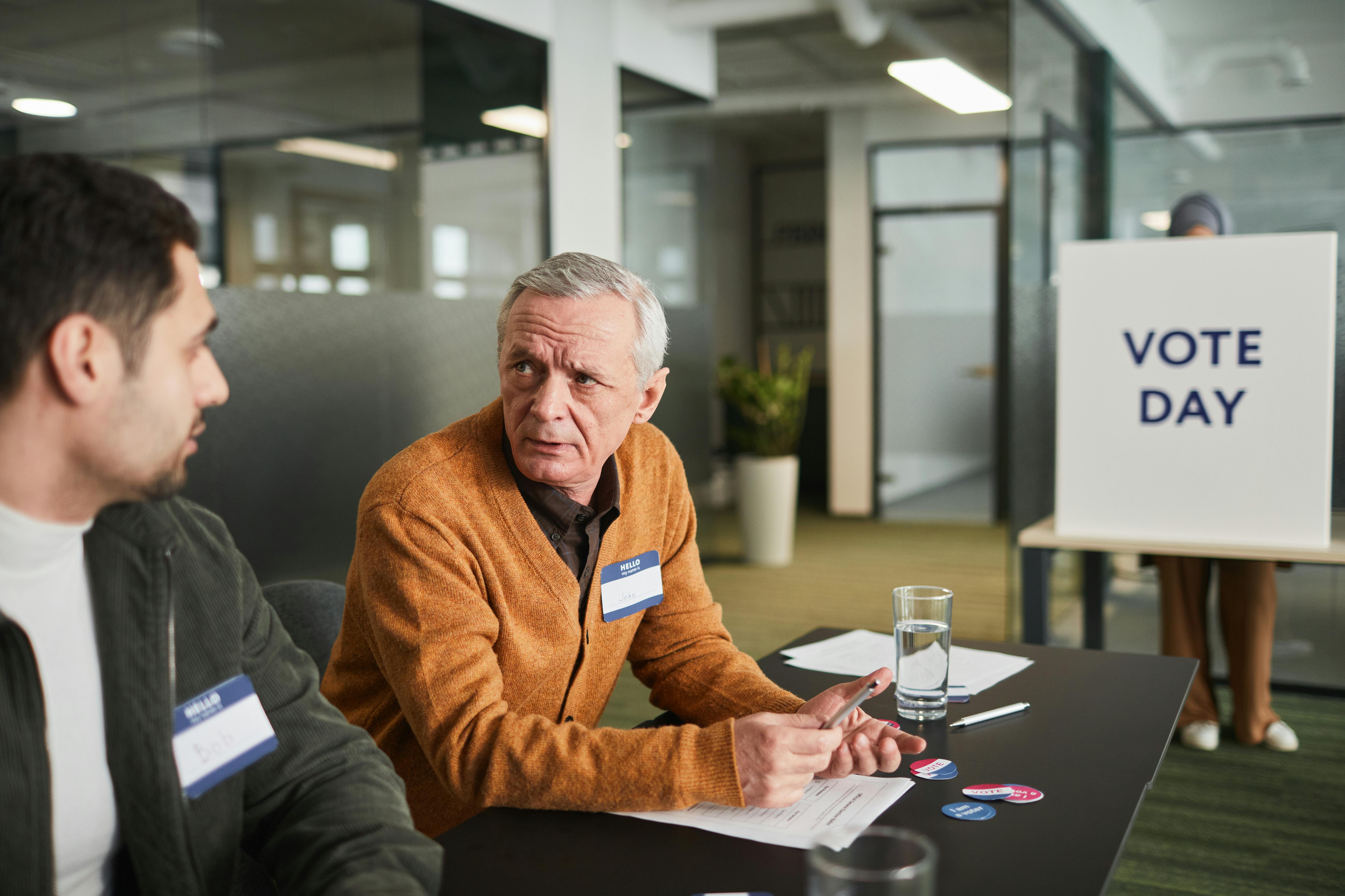 People wearing name badges at a meeting